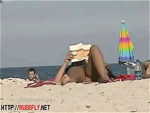 super-hot stunners filmed lounging on a nudist beach