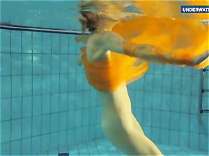Yellow and red clad teen underwater